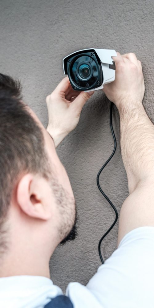 technician-worker-installing-video-surveillance-camera-wall